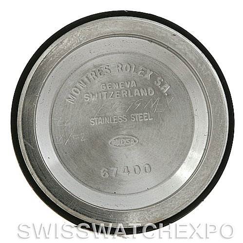 This image shows the back case of a Mid-Size Rolex watch, focusing on the engravings and markings.
