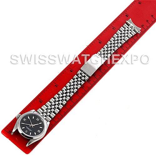 The image shows a top-down view of a Rolex Mid-Size 67480 Women's Stainless Steel Black Dial 67480 Women's Stainless Steel Black Dial model watch placed alongside a red ruler.