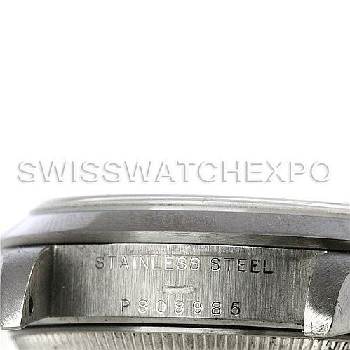 This image shows the side of a Mid-Size Rolex watch, focusing on the stainless steel case and serial number.