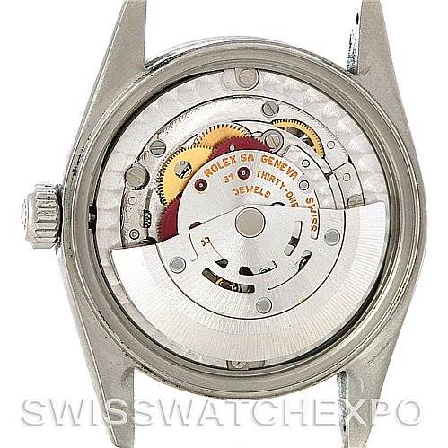 This image shows the open case back of a Rolex Mid-Size 78240 Women's Stainless Steel Black Dial 78240 Women's Stainless Steel Black Dial model, revealing the internal mechanical movement and gears.