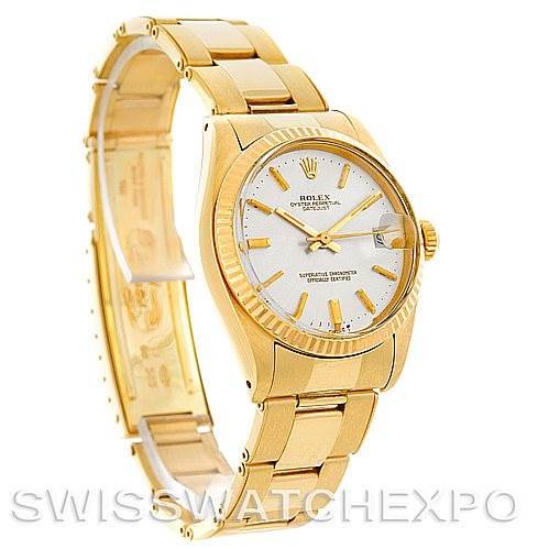 This image shows a predominantly side angle of a Rolex Mid-Size 6827 Women's Yellow Gold Silver Dial 6827 Women's Yellow Gold Silver Dial watch, highlighting its gold case, bracelet, and white dial.