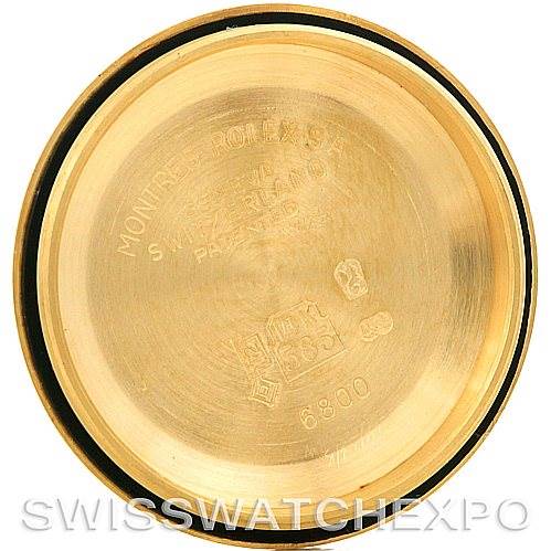 This image shows the interior of the case back of a Mid-Size Rolex watch, with inscriptions and markings visible.