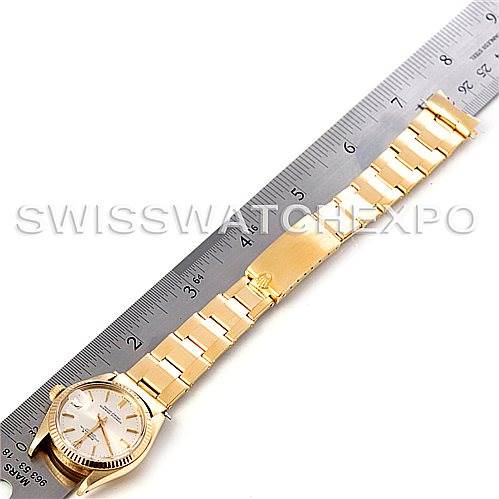 The image shows a Mid-Size Rolex watch laid flat with a metal ruler beside it to measure the length.