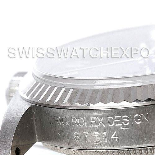 The image shows a close-up angle of the bezel and case side of a Mid-Size Rolex watch, highlighting the engraved text.