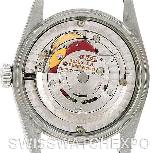 This image shows the back of a Mid-Size Rolex watch, revealing the internal movement and mechanical parts.