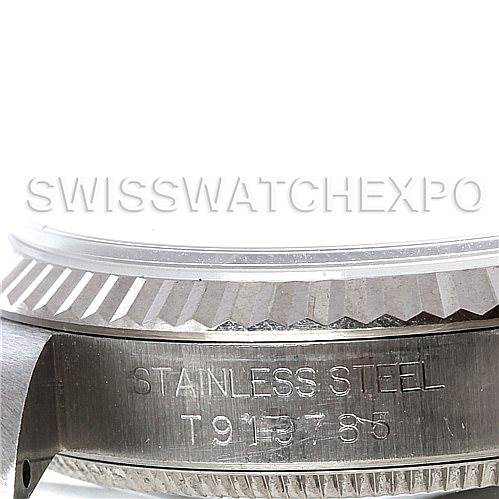 This image shows a close-up of the side view of a Rolex Mid-Size 67514 Women's Stainless Steel Blue Dial 67514 Women's Stainless Steel Blue Dial watch, focusing on the stainless steel case and the textured bezel.