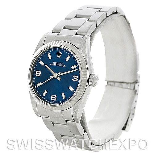 The image shows a Rolex Mid-Size 67514 Women's Stainless Steel Blue Dial 67514 Women's Stainless Steel Blue Dial Oyster Perpetual watch from a front angle, displaying its blue dial, metal bracelet, and clasp.