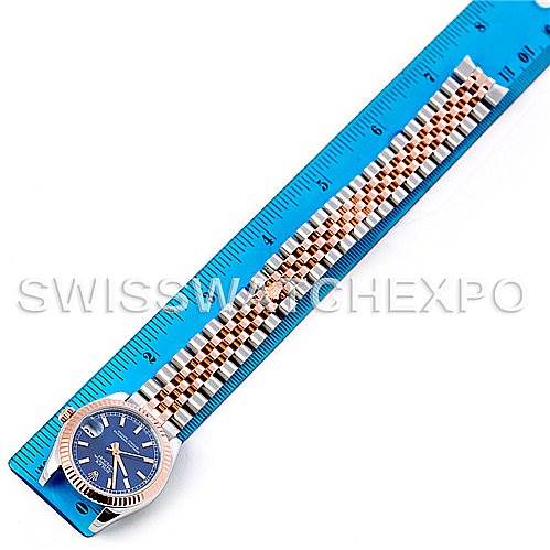 The image shows a Mid-Size Rolex watch with a blue dial, full bracelet, and a ruler for size reference.
