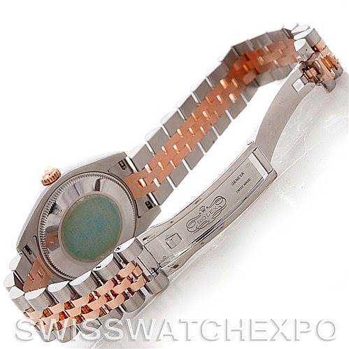 This image shows the back case and partially opened clasp of a mid-size Rolex watch with a two-tone bracelet.
