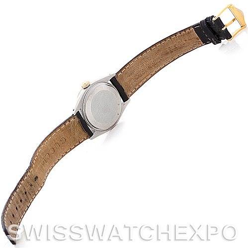 This image shows a Rolex Mid-Size 6827 Women's Stainless Steel White Dial 6827 Women's Stainless Steel White Dial watch from the back, displaying the case back, lugs, crown, and the inner side of the leather strap.