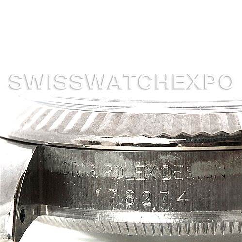 This image shows a side view of a Rolex Mid-Size 178274 Women
s Stainless Steel White Dial 178274 Women
s Stainless Steel White Dial watch, focusing on its engraved serial number and case details.