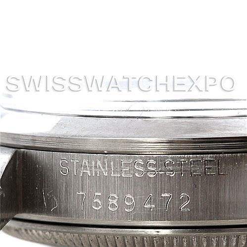 The image shows a close-up of the stainless steel case back of a Mid-Size Rolex watch displaying the serial number.