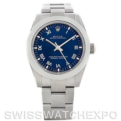 The image shows a front view of a Rolex Oyster Perpetual Mid-Size watch with a blue dial and stainless steel bracelet.
