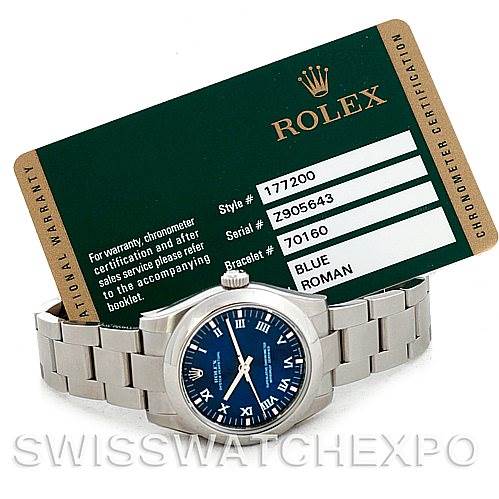 The image shows a Rolex Mid-Size 177200 Women's Stainless Steel Blue Dial 177200 Women's Stainless Steel Blue Dial watch model from a slight angle, along with its warranty card displaying model and serial numbers.