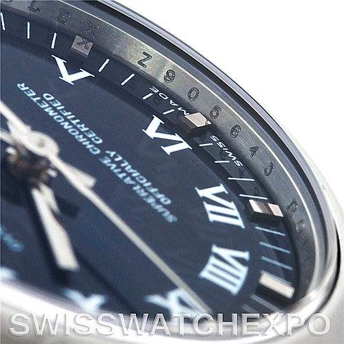 The image shows an angled close-up of the dial and bezel of a Mid-Size Rolex watch, highlighting the Roman numerals and minute markers.