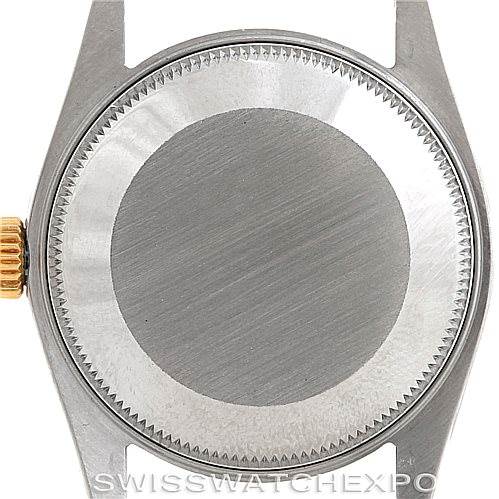 This image shows the back case of a mid-size Rolex watch, viewed from the rear with the crown on the left side.