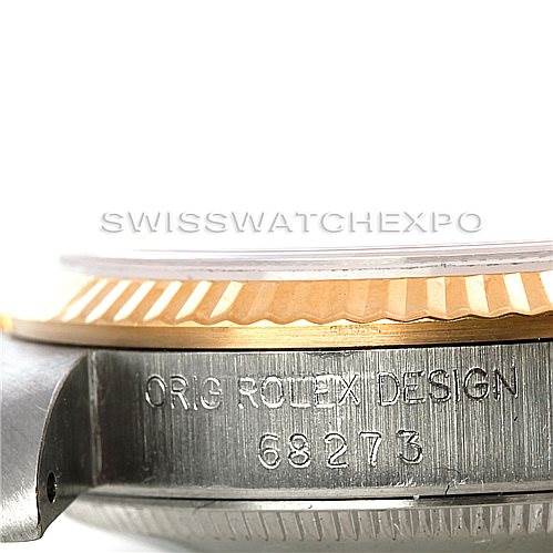 This image shows a close-up side angle of a Rolex Mid-Size 68273 Women's Stainless Steel Champagne Dial 68273 Women's Stainless Steel Champagne Dial watch, highlighting the engraved serial number and the edge of the bezel.
