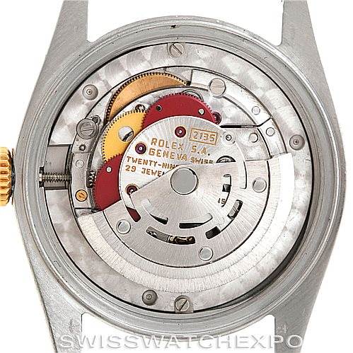 The image shows the back view of a mid-size Rolex watch, highlighting its internal mechanical movement.