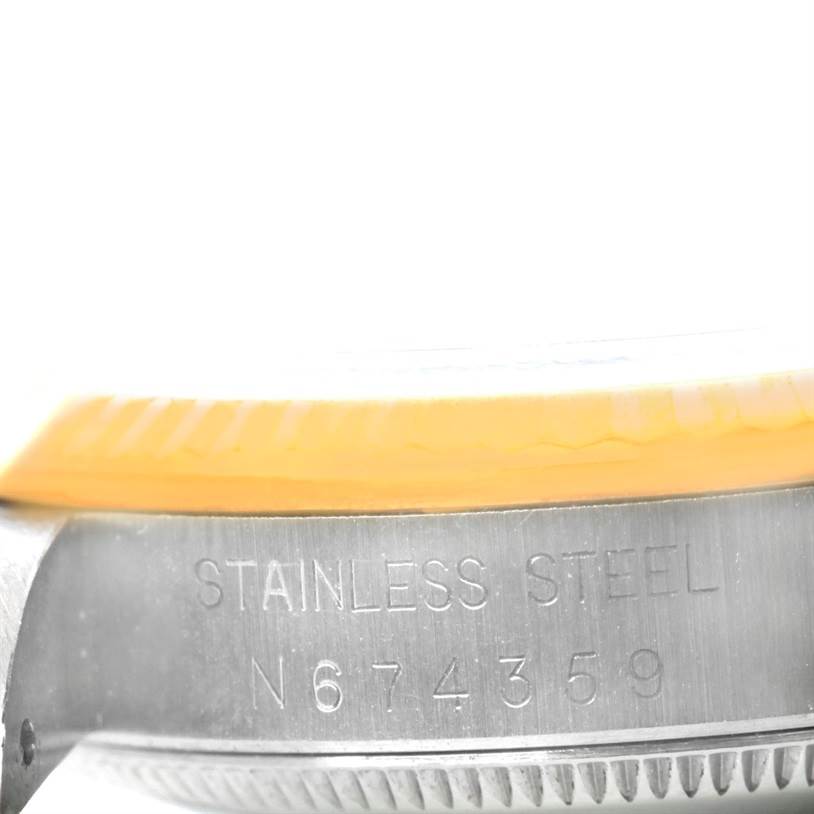 This image shows a close-up of the side of a stainless steel mid-size Rolex watch case, highlighting its serial number.