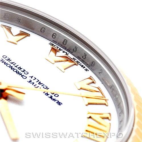 This image shows a close-up angle of a Rolex Mid-Size 178273 Women's Steel and Gold (two tone) White Dial 178273 Women's Steel and Gold (two tone) White Dial model watch, focusing on part of the dial, Roman numerals, and bezel.