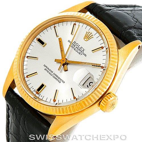 The image shows a Rolex Mid-Size 6827 Women's Yellow Gold Silver Dial 6827 Women's Yellow Gold Silver Dial watch at an angle displaying its dial, crown, bezel, and part of the leather strap.