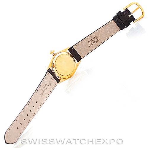 This image shows the backside of a Rolex Mid-Size 6827 Women's Yellow Gold Silver Dial 6827 Women's Yellow Gold Silver Dial model watch with the strap fully extended, displaying the clasp and inner leather strap.
