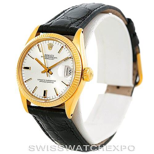 This image shows a side angle of a Rolex Mid-Size 6827 Women's Yellow Gold Silver Dial 6827 Women's Yellow Gold Silver Dial watch, highlighting the face, bezel, lugs, and part of the leather strap.