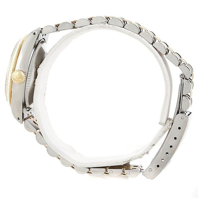 The image shows a side view of a Mid-Size Rolex watch, highlighting the crown, part of the case, and the bracelet.