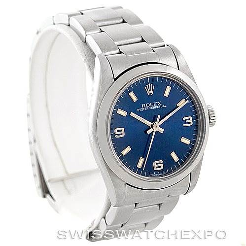 This image shows a Rolex Oyster Perpetual Mid-Size watch from a front-left angle, highlighting the blue dial, stainless steel case, and bracelet.