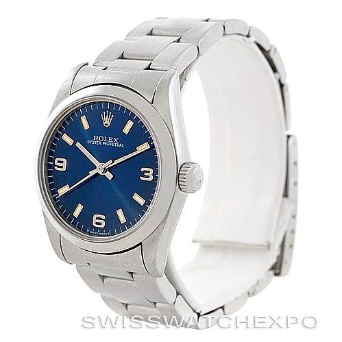 This image shows a side-angle view of a Rolex Mid-Size 67480 Women's Stainless Steel Blue Dial 67480 Women's Stainless Steel Blue Dial Oyster Perpetual watch, highlighting the face, bezel, bracelet, and clasp.