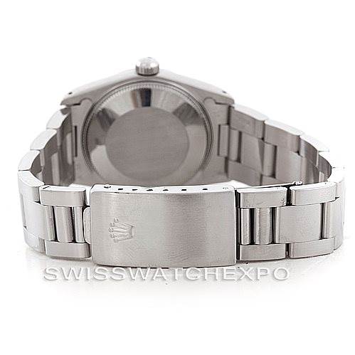 The image shows the back view of a Rolex Mid-Size 67480 Women's Stainless Steel Silver Dial 67480 Women's Stainless Steel Silver Dial model, highlighting the case back and the metal bracelet with the clasp.