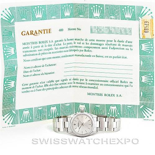 The image shows a Rolex Mid-Size 67480 Women's Stainless Steel Silver Dial 67480 Women's Stainless Steel Silver Dial watch in a front view along with its warranty certificate displayed in the background.