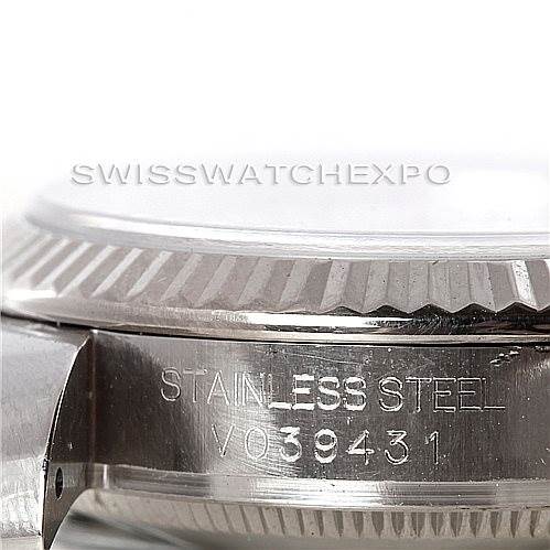 The image shows a side angle of the Rolex Mid-Size 178274 Women's Stainless Steel White Dial 178274 Women's Stainless Steel White Dial watch, highlighting the stainless steel casing and the engraving of its serial number.