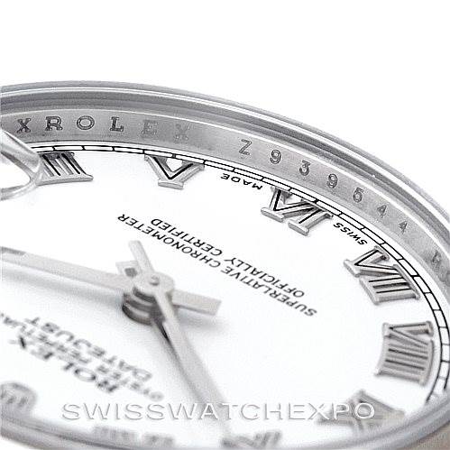 Close-up of a Rolex Mid-Size 178240 Women's Stainless Steel White Dial 178240 Women's Stainless Steel White Dial watch, showing the dial, Roman numeral hour markers, partial hands, and the serial number on the bezel.