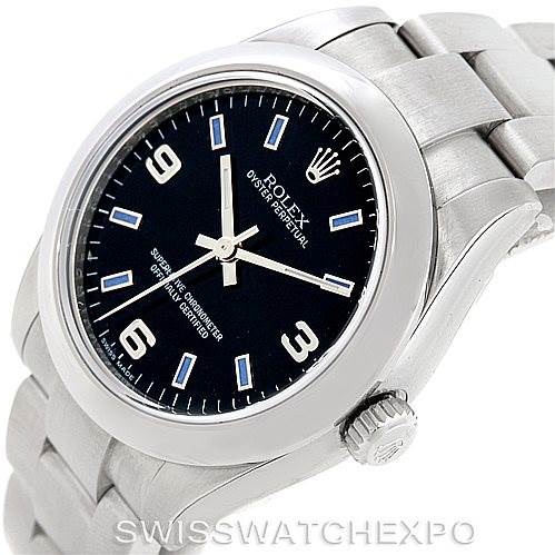 This image shows a Mid-Size Rolex watch at a tilted angle, displaying its black dial, hour markers, hands, and partially the bracelet.