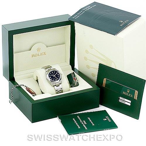The image shows a Mid-Size Rolex watch in a green display box with its accessories, including a warranty card, manual, and outer box.