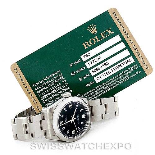 The image shows a Rolex Oyster Perpetual Mid-Size watch at a slight angle along with its certification card.