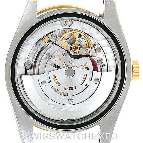 This image shows the movement and internal components of a mid-size Rolex watch from the back.