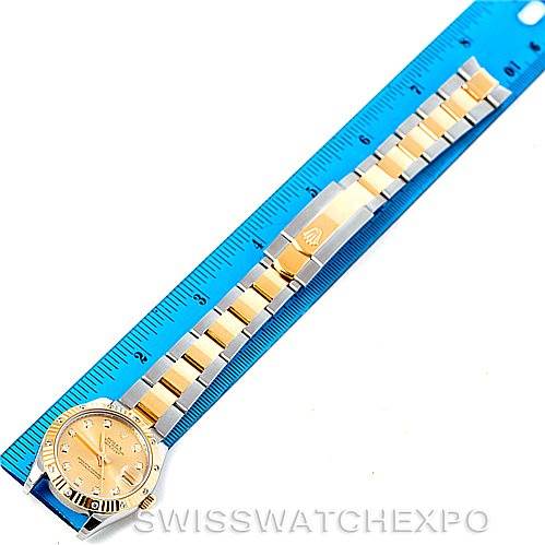 This image shows the full bracelet and face of a Rolex Mid-Size 178313 Women's Stainless Steel Champagne Dial 178313 Women's Stainless Steel Champagne Dial watch laid flat next to a blue ruler for scale.