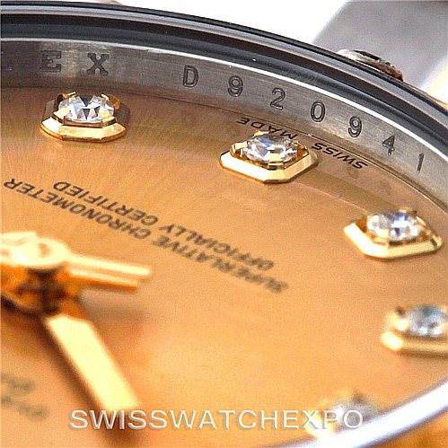 This close-up of the Rolex Mid-Size 178313 Women's Stainless Steel Champagne Dial 178313 Women's Stainless Steel Champagne Dial model features the dial, part of the bezel, and diamond hour markers.