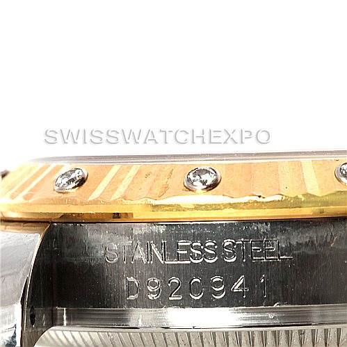 The image shows a close-up of a Mid-Size Rolex watch's bezel and case side, highlighting its stainless steel material and serial number.