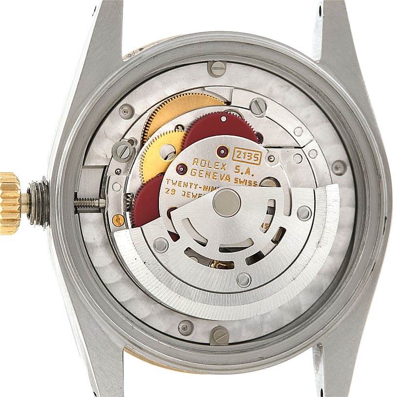 This image shows the movement mechanism of a mid-size Rolex watch with its back cover removed.