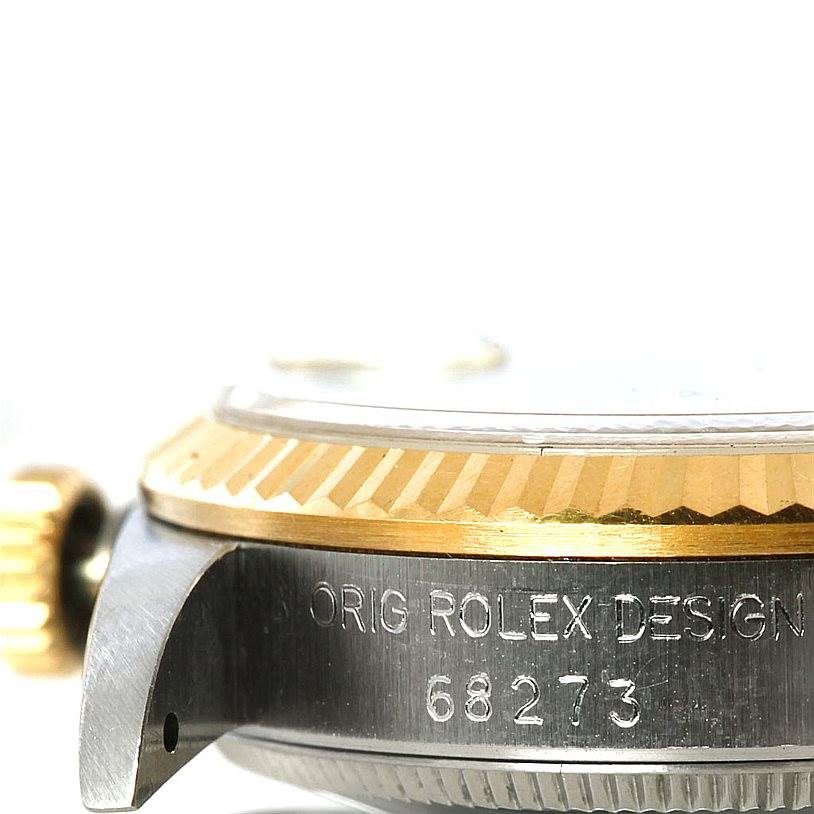 This image shows a close-up view of the side of a Rolex Mid-Size 68273 Women's Stainless Steel Blue Dial 68273 Women's Stainless Steel Blue Dial model watch, displaying part of the bezel and case with the model number 68273 engraved.