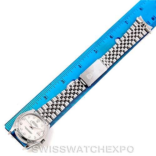 This image shows a top view of a Rolex Mid-Size 68274 Women's Stainless Steel Silver Dial 68274 Women's Stainless Steel Silver Dial model watch, displaying the face, bezel, and stainless steel bracelet alongside a ruler.