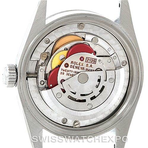 The image shows the inner mechanism of a Rolex Mid-Size 68274 Women's Stainless Steel Silver Dial 68274 Women's Stainless Steel Silver Dial model watch from the back, displaying its movement and parts.