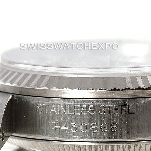 This image shows a close-up of the casing side of a Mid-Size Rolex watch, with visible stainless steel and the serial number.