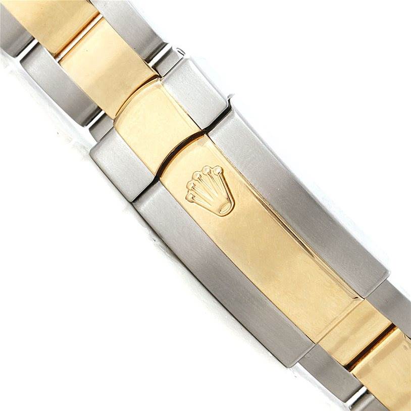 The image shows a close-up view of the stainless steel and gold bracelet clasp of a mid-size Rolex watch.