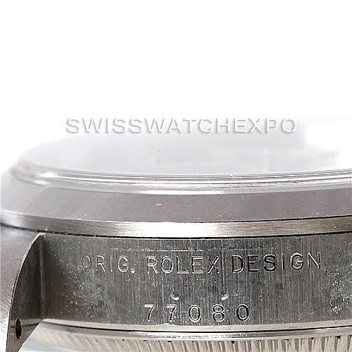 This image shows a close-up, side view of the case of a Mid-Size Rolex watch, highlighting the engraved model number and design inscription.