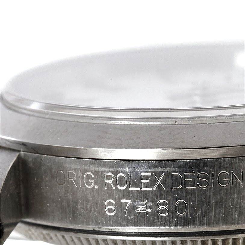 This image shows a side close-up of the casing and bezel of a Mid-Size Rolex model, including the "ORIG. ROLEX DESIGN" engraving.