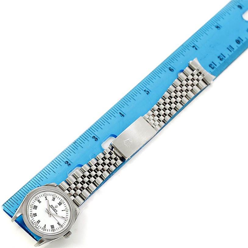 The image shows a Rolex Mid-Size 67480 Women's Stainless Steel White Dial 67480 Women's Stainless Steel White Dial watch from a top-down angle, displaying its face, bracelet, and clasp.